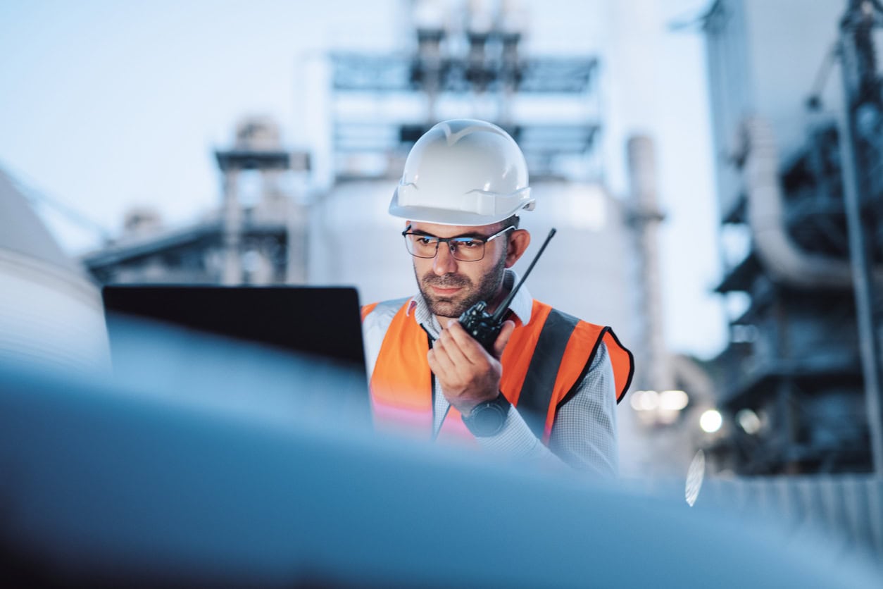 Engineer is reptorting a problem with a walkie talkie on the power station at a night shift.